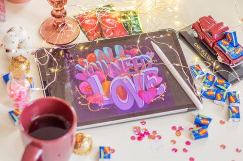 pink and white ceramic mug beside ipad with digital product creation